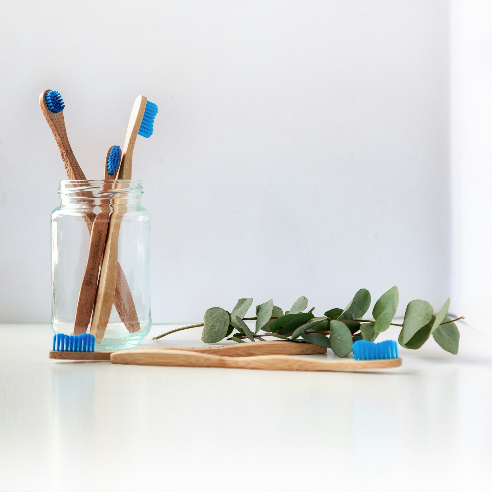 A tidy bathroom counter with an electric toothbrush and daily care items