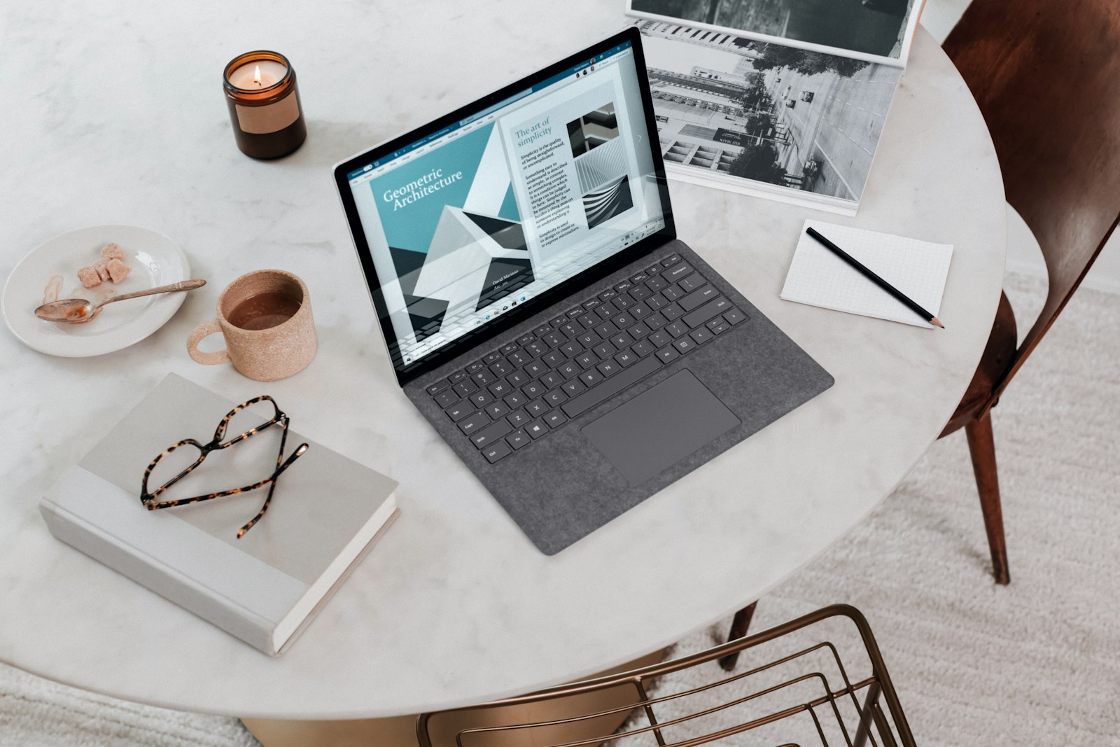 A remote worker at a tidy desk with a webcam and monitor